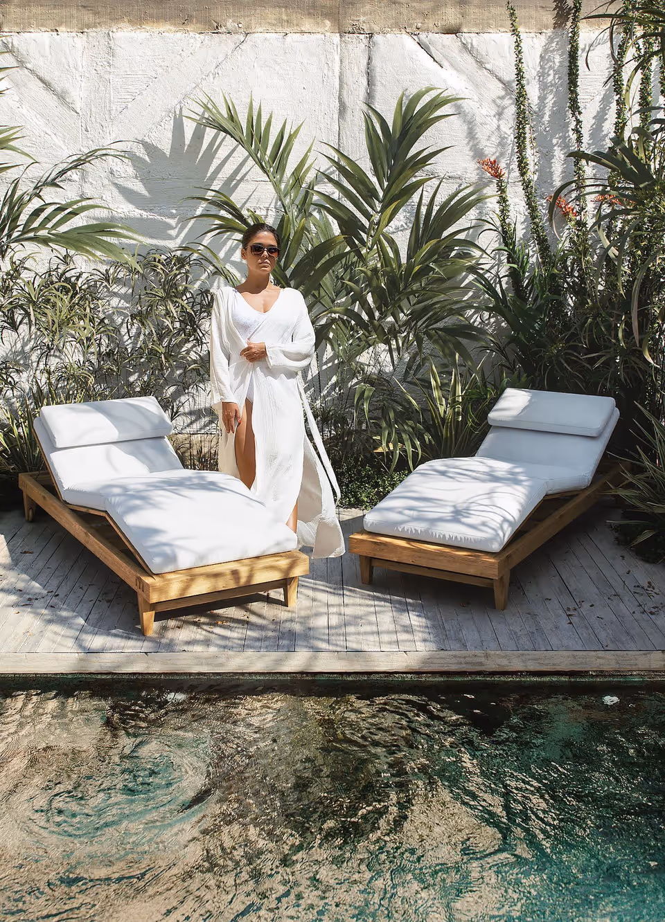 3D rendered deck chairs t in a poolside setting